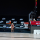 A reporter sits courtside in an empty arena during August’s NBA strike.